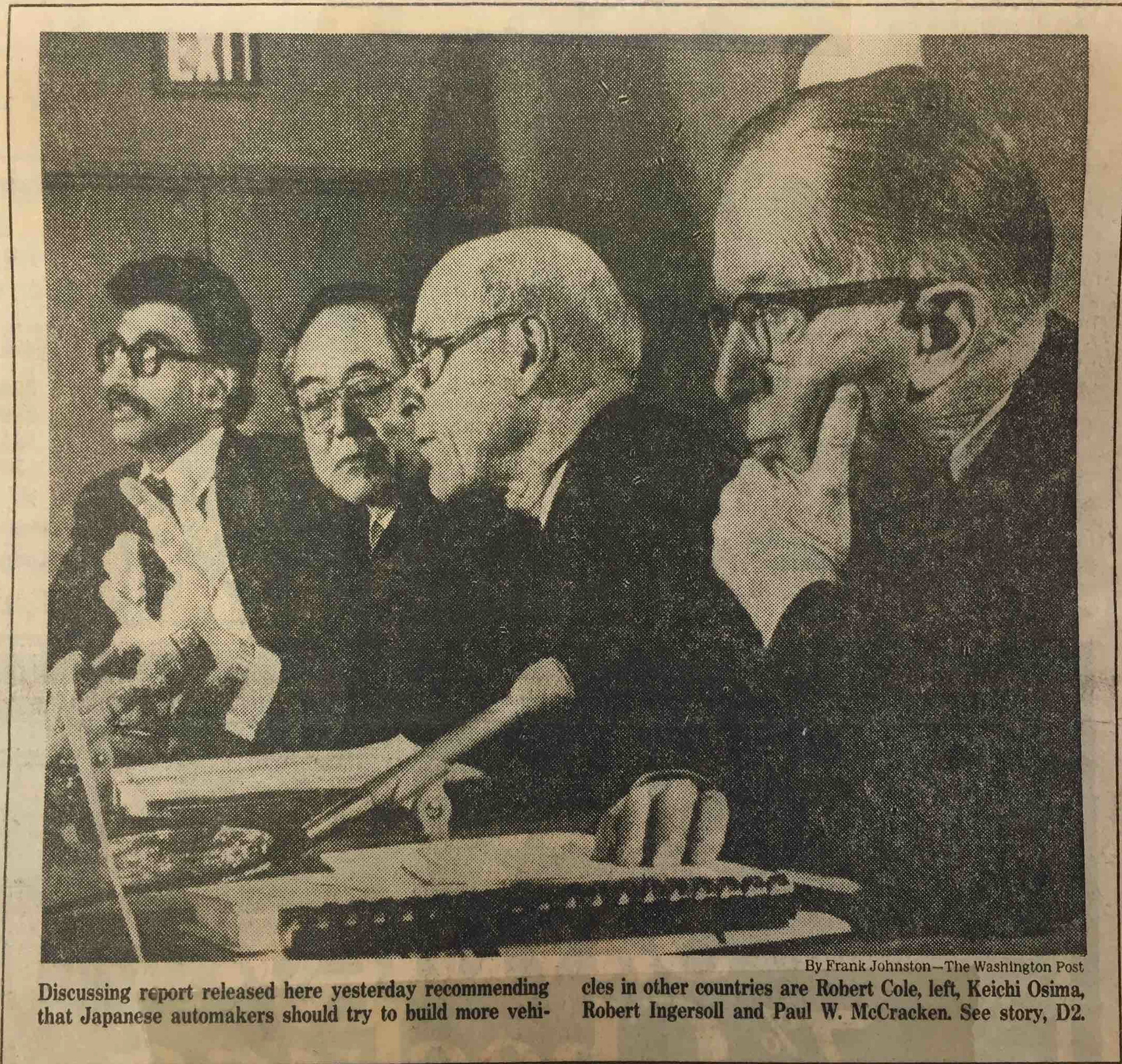 Four men seated at a table